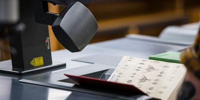 A student checking out a book in the Edward Boyle Library.