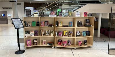 A shelf filled with LGBT+ books in the Laidlaw Library
