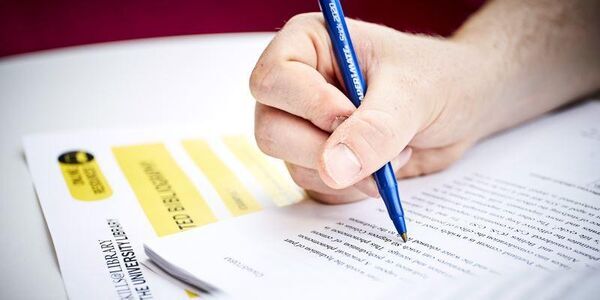 Making notes with pen and paper
