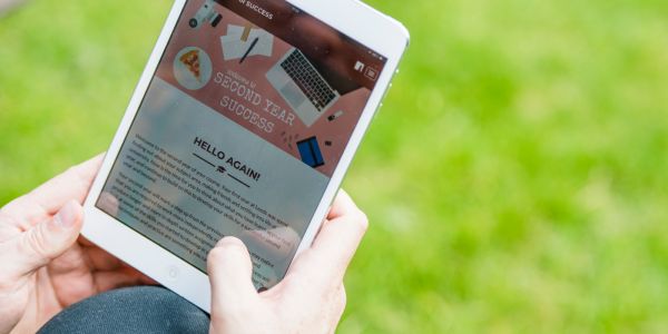 Student accessing Second Year Success resource in the park via a tablet