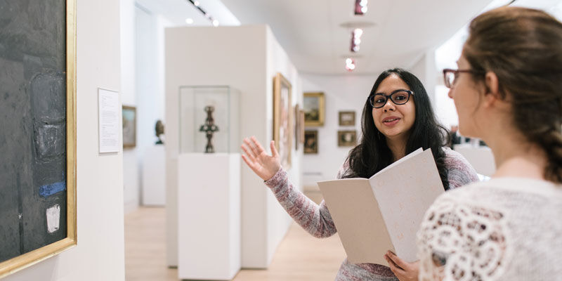 Visitors discussing an artwork in The Stanley and Audrey Burton Gallery